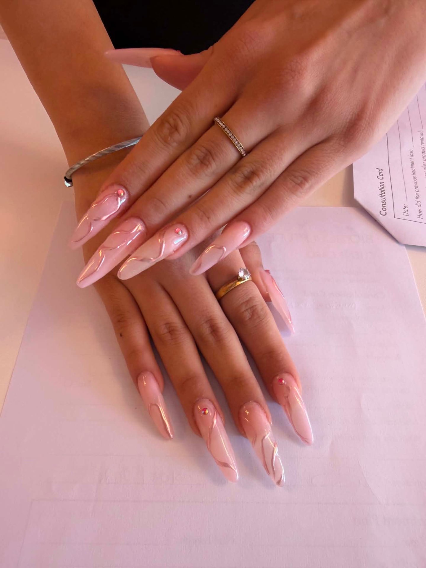 Nude pink long nails with glossy swirl art