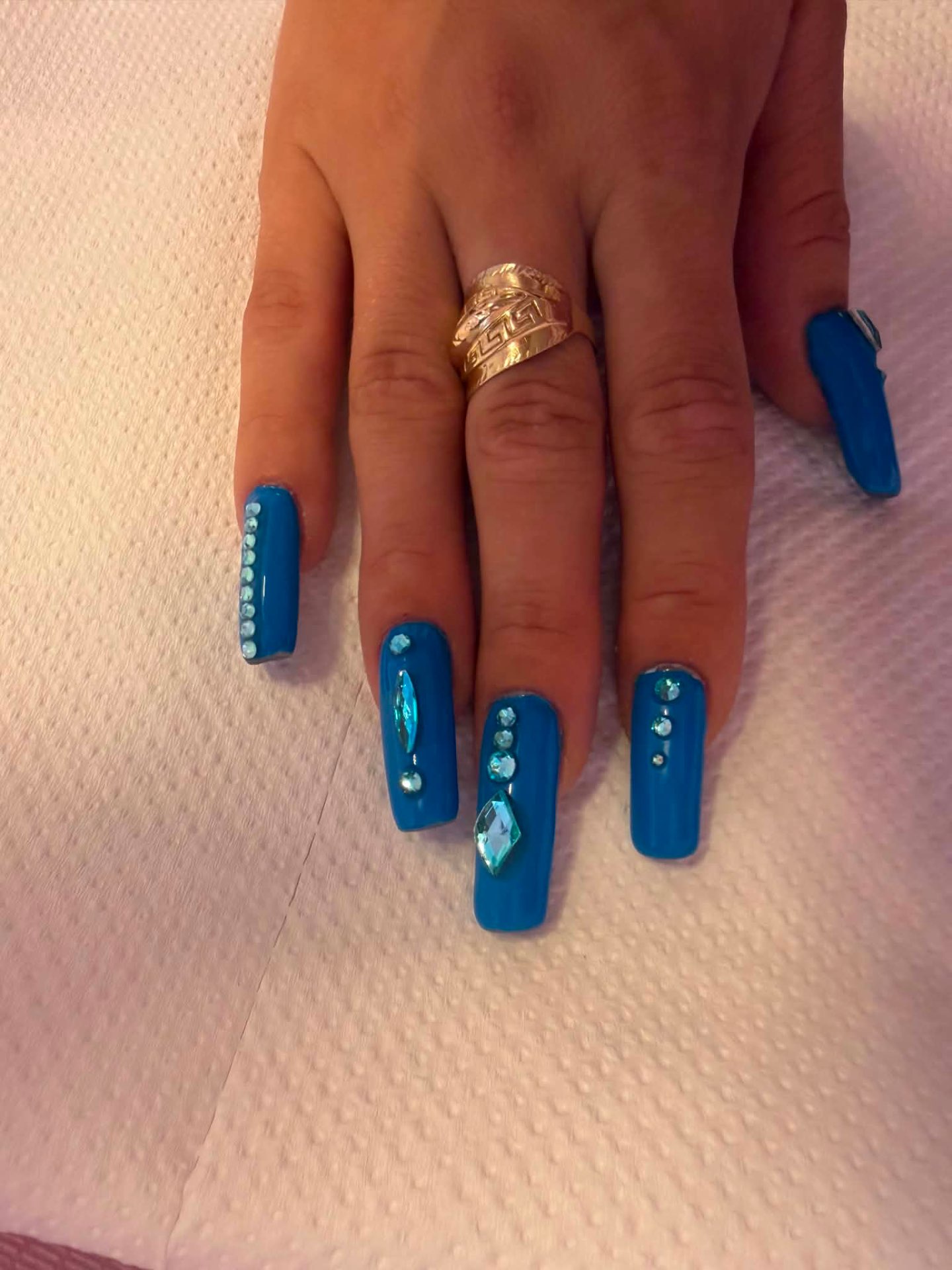 Bright blue square nails with aqua gems
