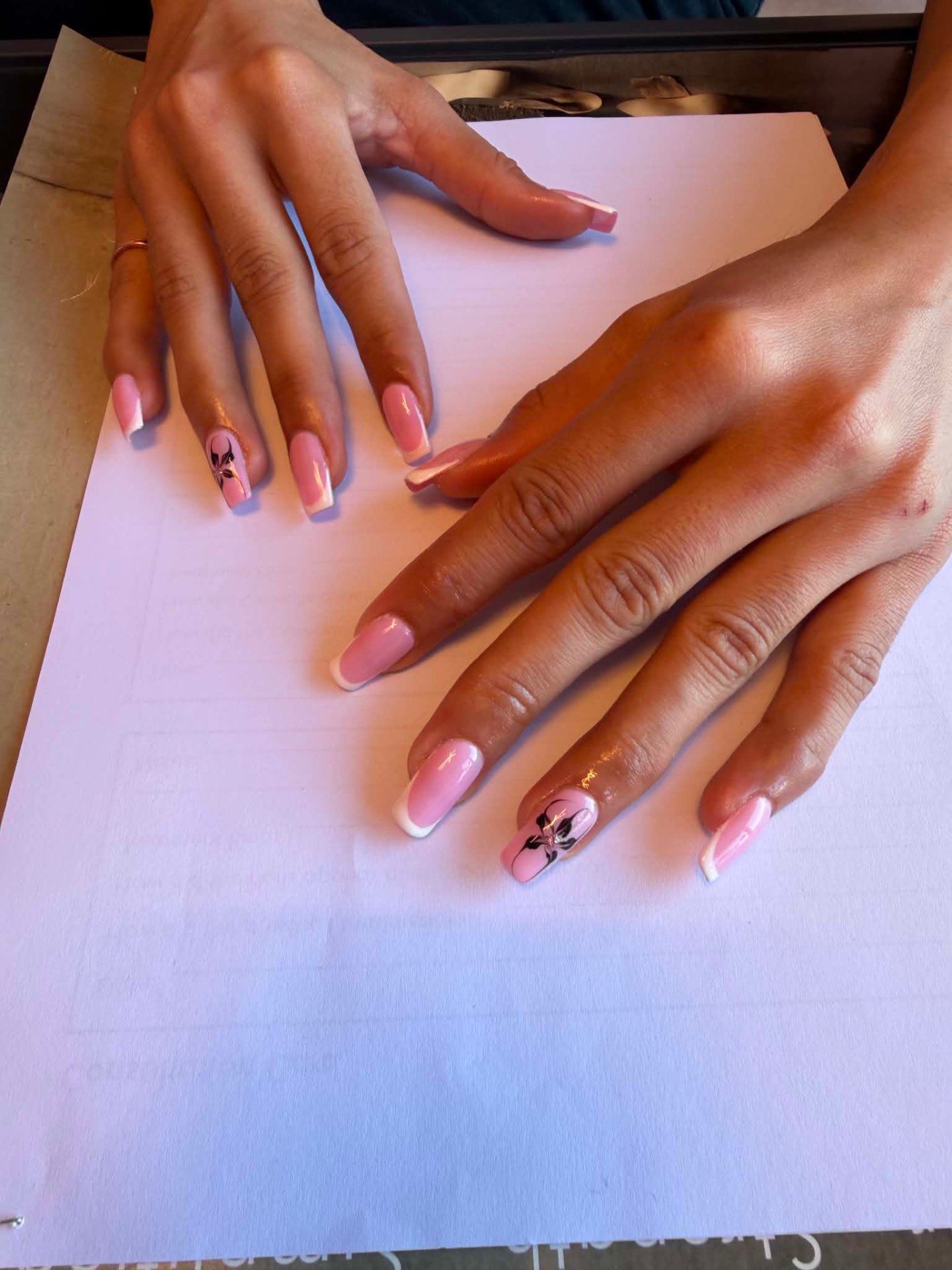 Pink French nails with delicate flower accents